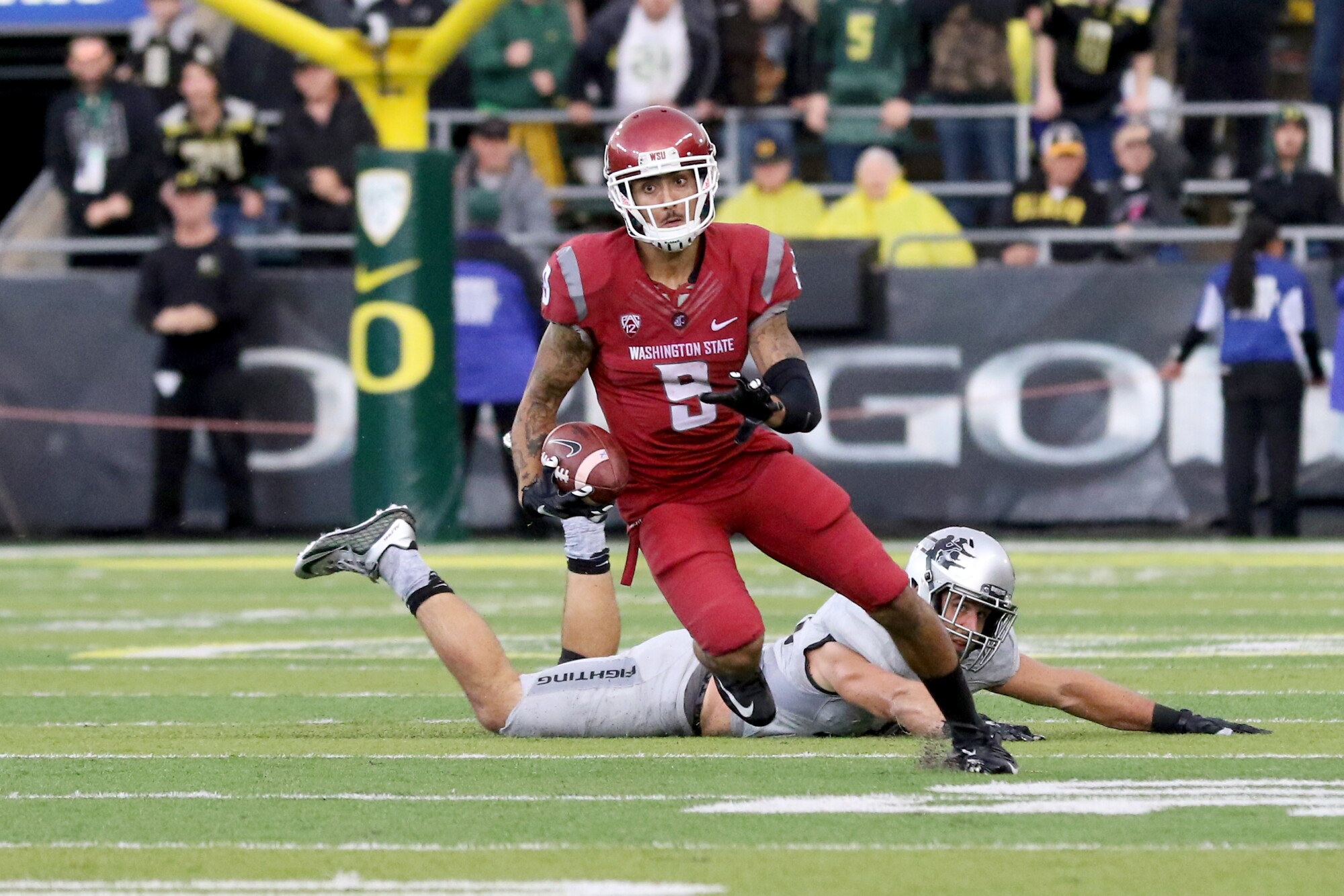 Gabe Marks leaves an Oregon defender on the ground after making a reception for Washington State.