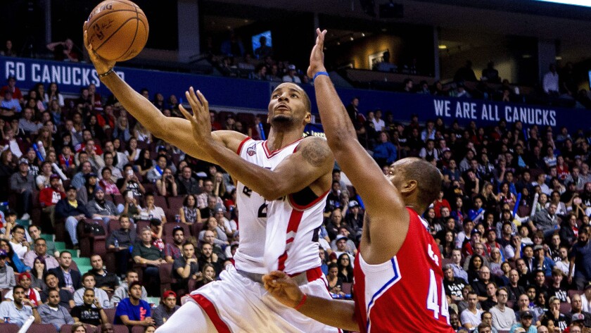 Forward Chuck Hayes challenges a shot by Raptors guard Norman Powell during a Clippers preseason game on Oct. 4.