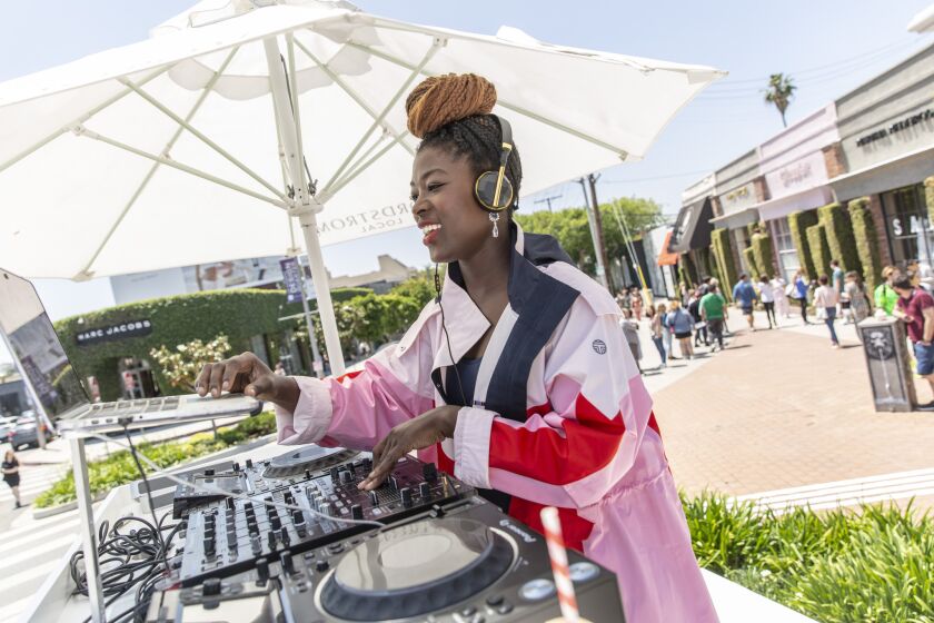DJ Val Fleury spins tunes outside of the Nordstrom Local shop on Melrose Place on May 4, 2019.