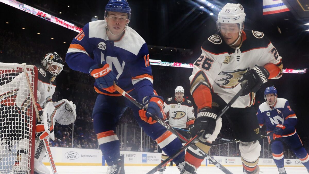 New York Islanders' Anthony Beauvillier and Ducks' Brandon Montour battle for the puck during the third period on Sunday.