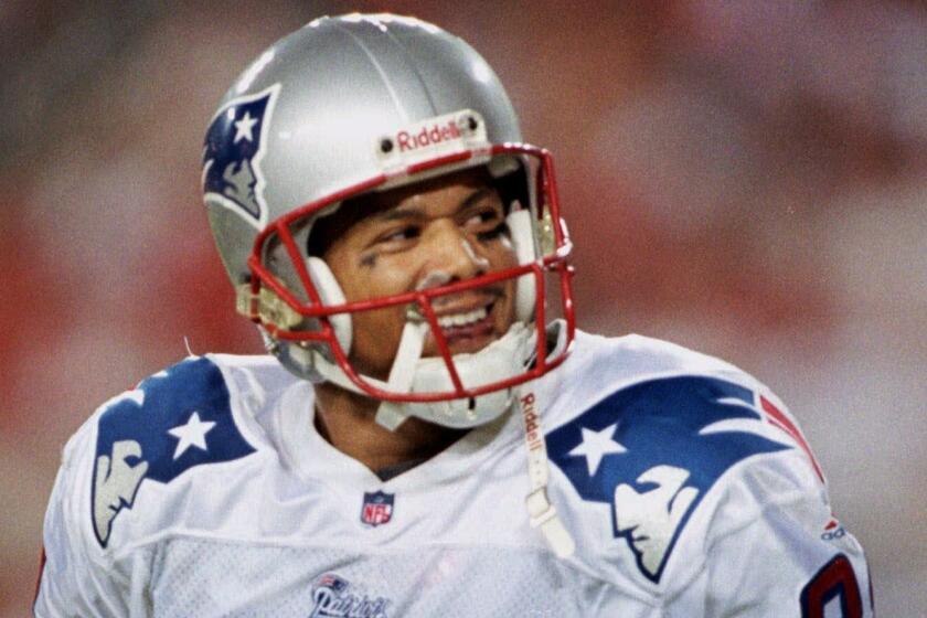 FILE - In this Aug. 28, 1999, file photo, then-New England Patriots wide receiver Terry Glenn looks back at hecklers behind the end zone after catching a touchdown pass from quarterback Drew Bledsoe during the second quarter against the Tampa Bay Buccaneers at Raymond James Stadium in Tampa, Fla. Officials say former Cowboys receiver Terry Glenn has died following a one-vehicle rollover traffic accident near Dallas that left his fiancée slightly hurt. The Dallas County Medical Examiners office says Glenn died at 12:52 a.m. Monday, Nov. 20, 2017, at Parkland Memorial Hospital in Dallas. The ex-Ohio State standout was 43.(AP Photo/Chris O'Meara, File)