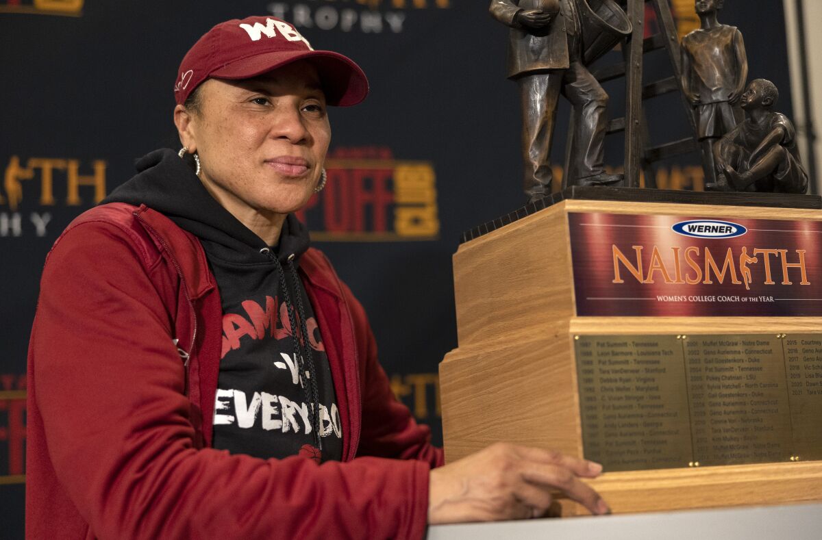 South Carolina coach Dawn Staley poses with a trophy after being named Naismith Women's College Coach of the Year, Wednesday, March 30, 2022, in Minneapolis. (Carlos Gonzalez/Star Tribune via AP)