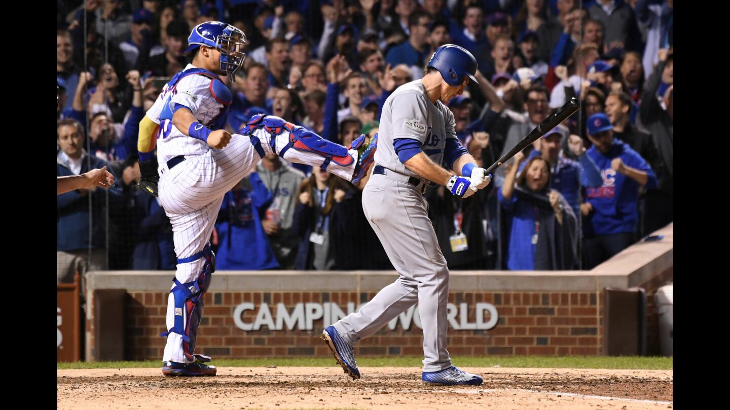 The Cubs' Willson Contreras celebrates after the Dodgers' Chase Utley, right, strikes out with two men on base in the eighth inning.