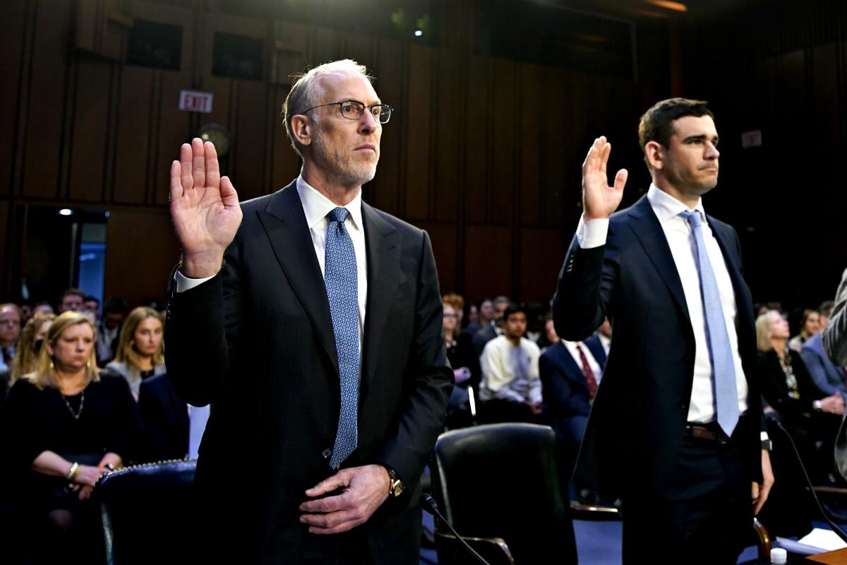 Two men in suits testifying before a Congressional subcommittee