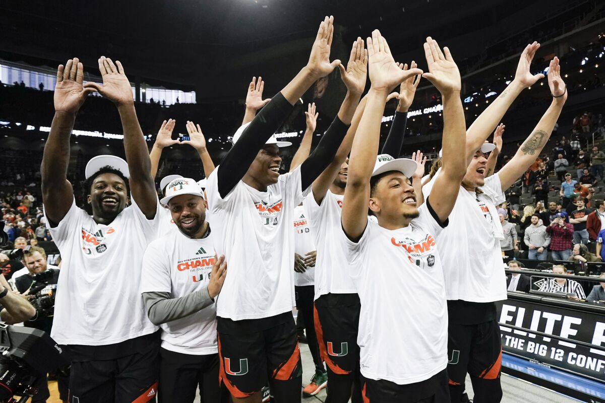Miami celebrates after their win against Texas in an Elite 8 college basketball game in the Midwest Regional of the NCAA Tournament Sunday, March 26, 2023, in Kansas City, Mo. (AP Photo/Charlie Riedel)