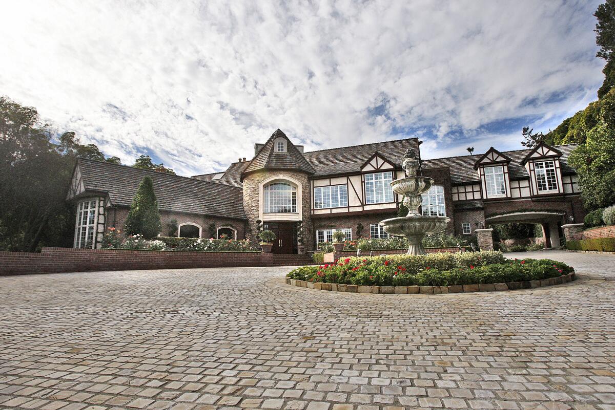 The front of the house with a recently laid, 14,000 square foot cobblestone driveway at the home of Robin Dorman in La Canada Flintridge on Monday, December 16, 2013. The Dorman's bought the abandoned, run-down Georgian colonial home 14 years ago, and have recently listed it for sale for $13 million, the highest price for a home in La Canada Flintridge history.