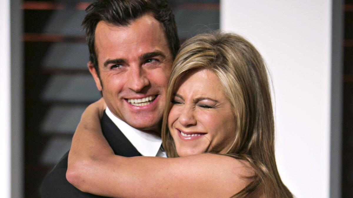 Justin Theroux and Jennifer Aniston, shown arriving at Vanity Fair's 2015 Oscar party, got married at their Bel-Air home Wednesday night.