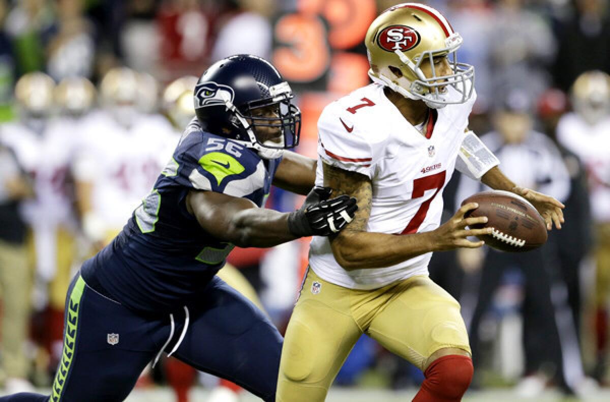 Seahawks linebacker Cliff Avril forces a fumble by 49ers quarterback Colin Kaepernick in the first half of their game earlier this season.