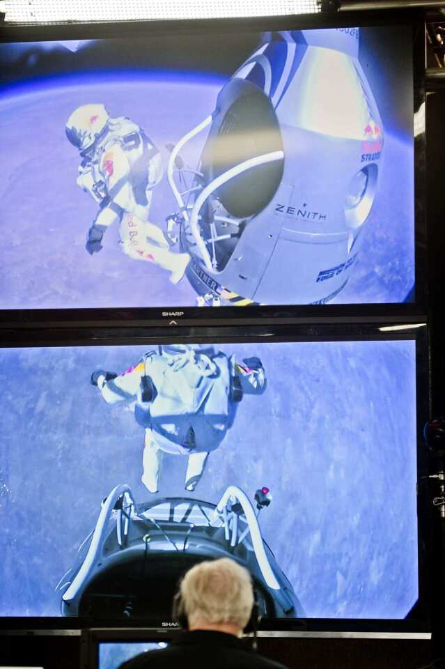 Mission control screens show pilot Felix Baumgartner of Austria jumping out from the capsule.