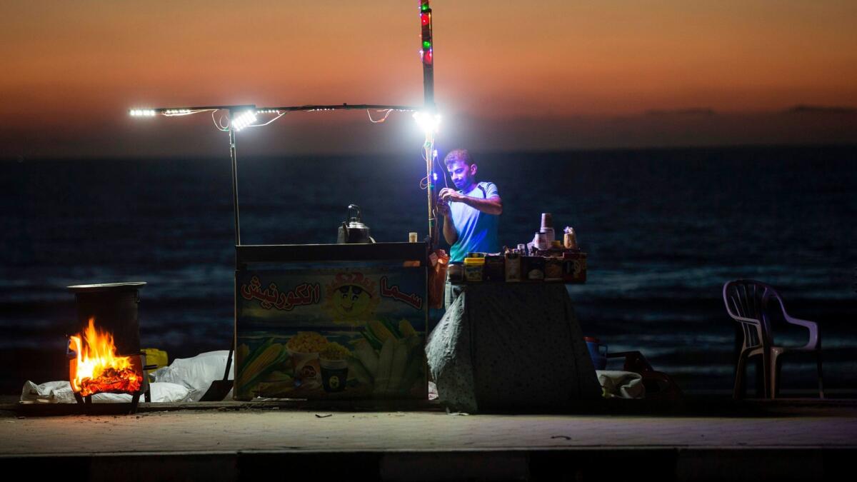 A Palestinian street vendor in Gaza City during a power outage in June.