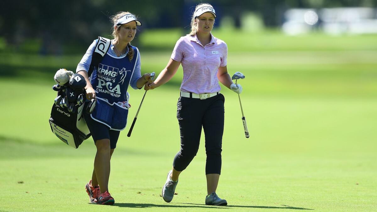 Brooke Henderson pulls a club from her caddie and sister Brittany Henderson on the ninth hole during the second round of the KPMG Women's PGA Championship at Kemper Lakes Golf Club on June 29, 2018 in Kildeer, Ill.