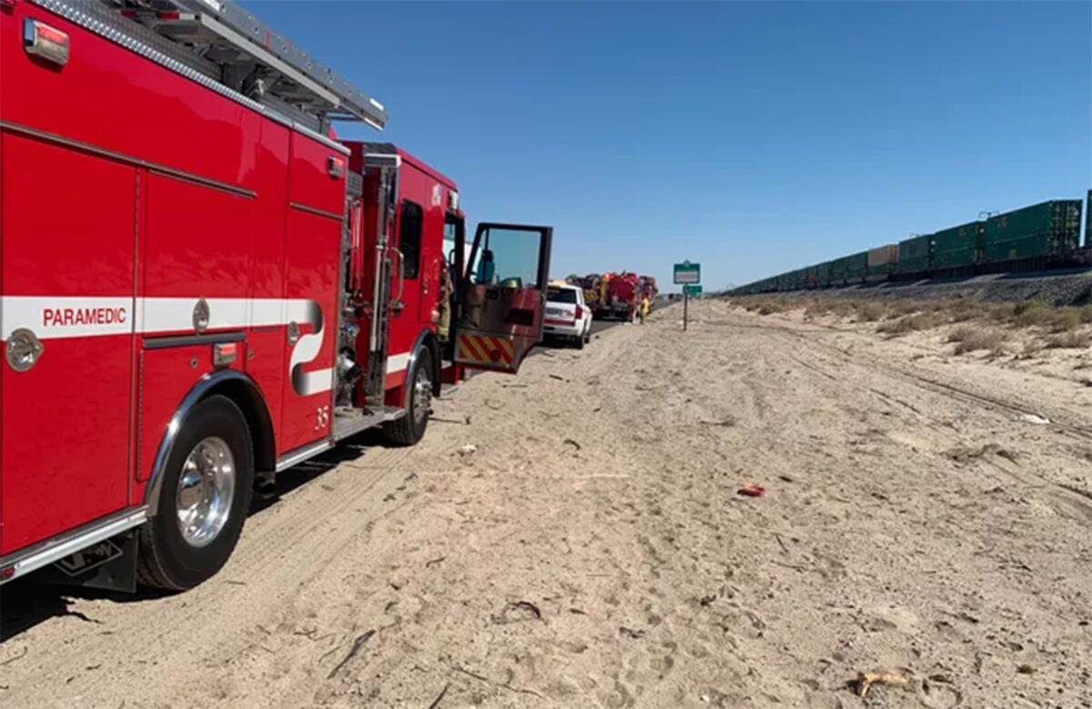 Officials respond to a fire Friday near the 10 Freeway in Palm Desert.