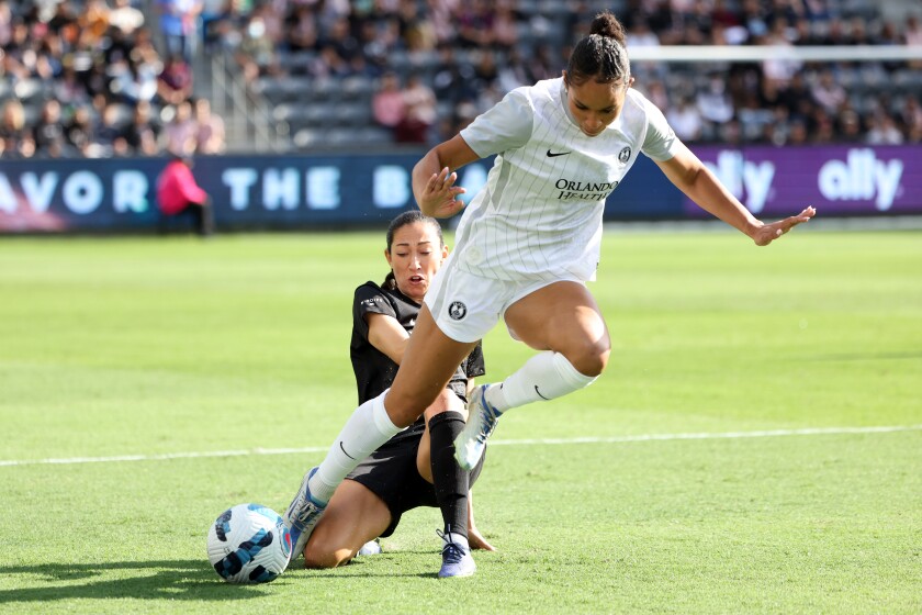 Angel City's Christen Press slide faces Orlando's Darian Jenkins during the first half of Angel City's 1-0 defeat on Sunday.