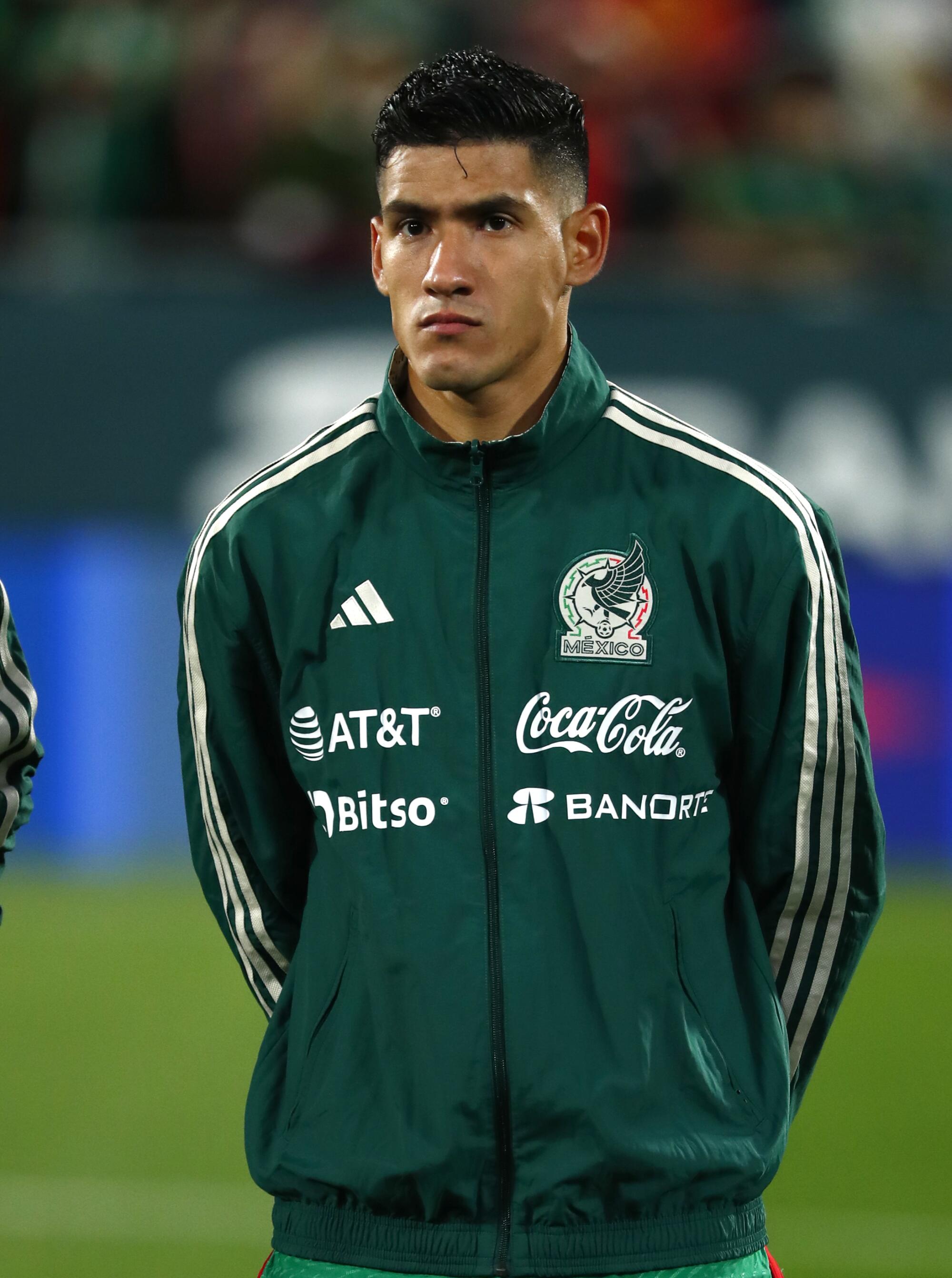 Uriel Antuna prepares to warm up with Mexico teammates before an international friendly against Sweden.