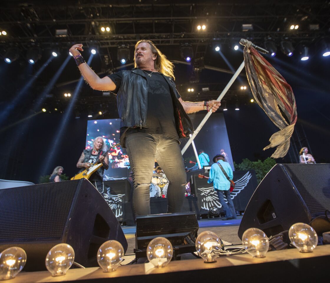 Lynyrd Skynyrd guitarists Rickey Medlocke, left, vocalist Johnny Van Zant, middle, and Gary Rossington (the band's sole continuous member), perform on the Palomino Stage on the second of the three-day 2019 Stagecoach Country Music Festival.