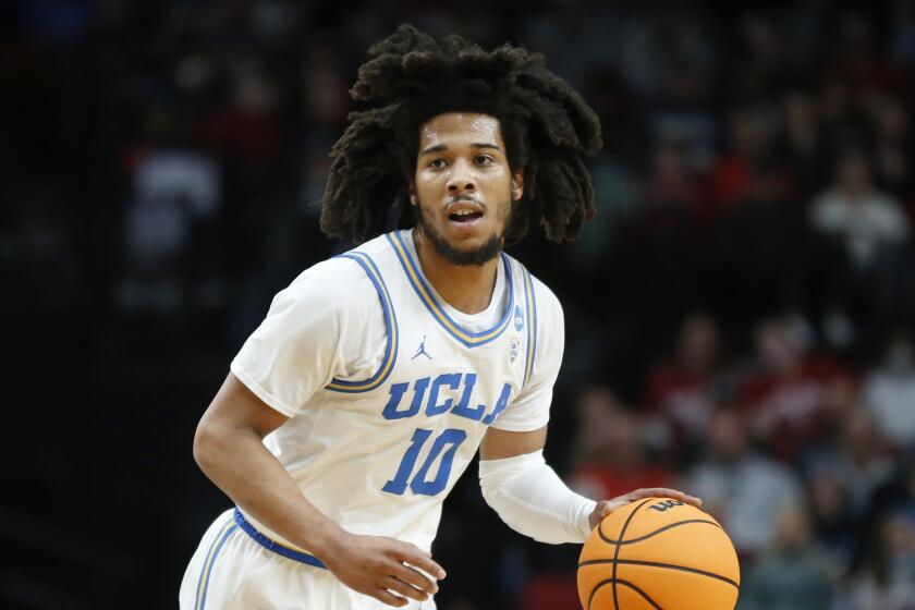 UCLA guard Tyger Campbell (10) dribbles and surveys the court against Akron
