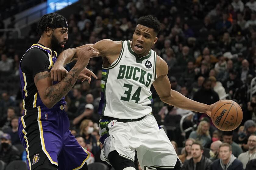 Milwaukee Bucks' Giannis Antetokounmpo tries to get past Los Angeles Lakers' Anthony Davis during the second half of an NBA basketball game Wednesday, Nov. 17, 2021, in Milwaukee. The Bucks won 109-102. (AP Photo/Morry Gash)