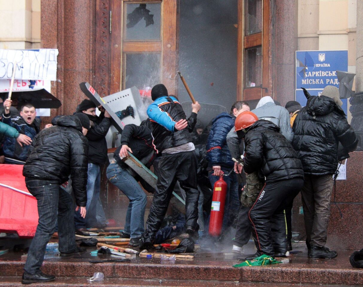 Russian activists clash with opposition fighters as they storm the regional government building in Kharkiv.