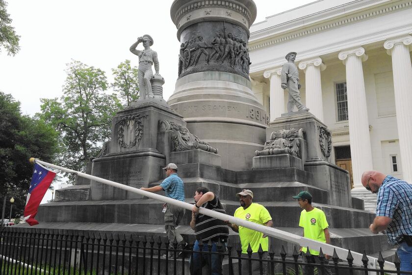 Workers remove a Confederate flag from the grounds of the Alabama state Capitol in Montgomery, on the orders of Gov. Robert J. Bentley.