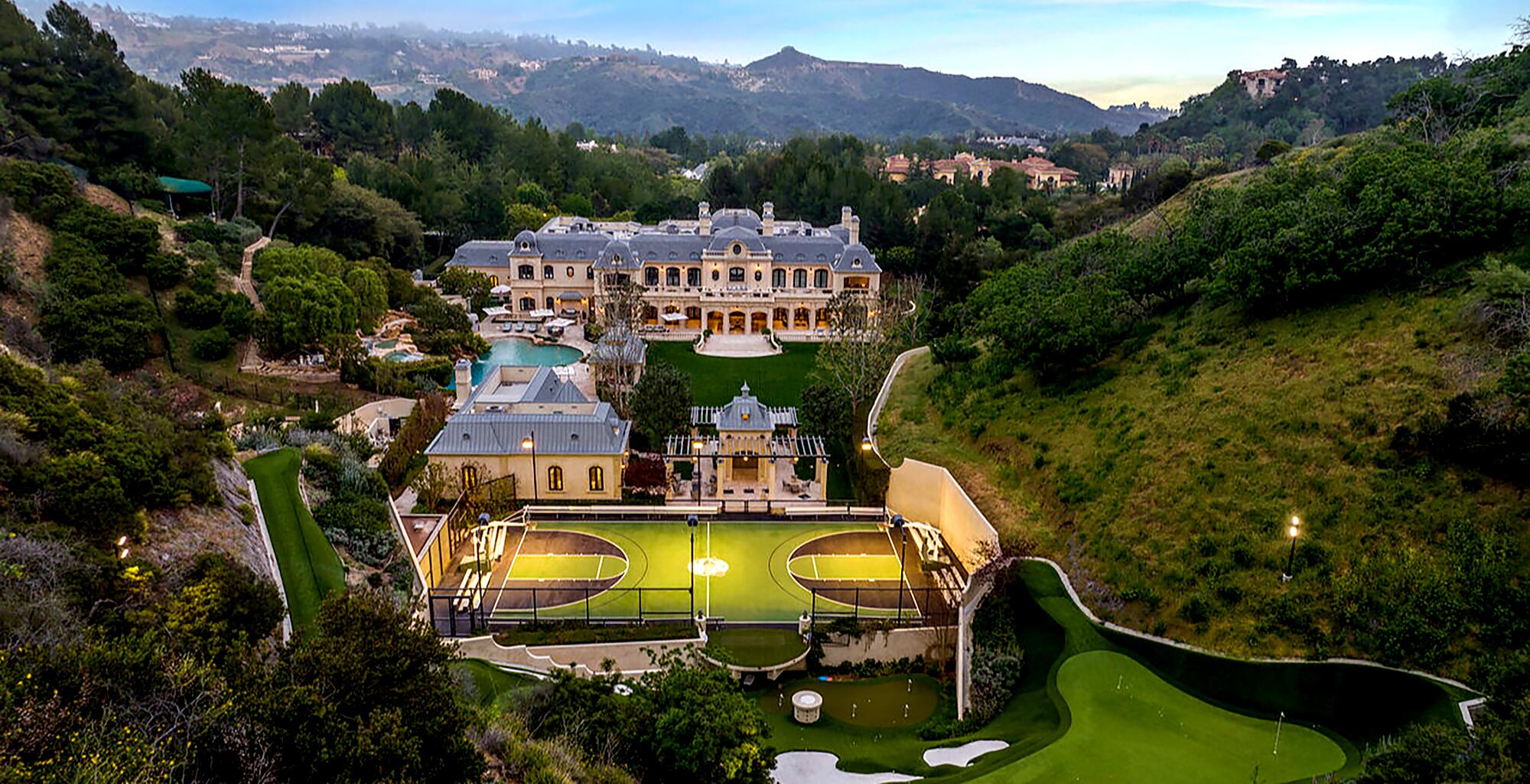 Mark Wahlberg's Beverly Park mega-mansion with basketball court, surrounded by green hills.
