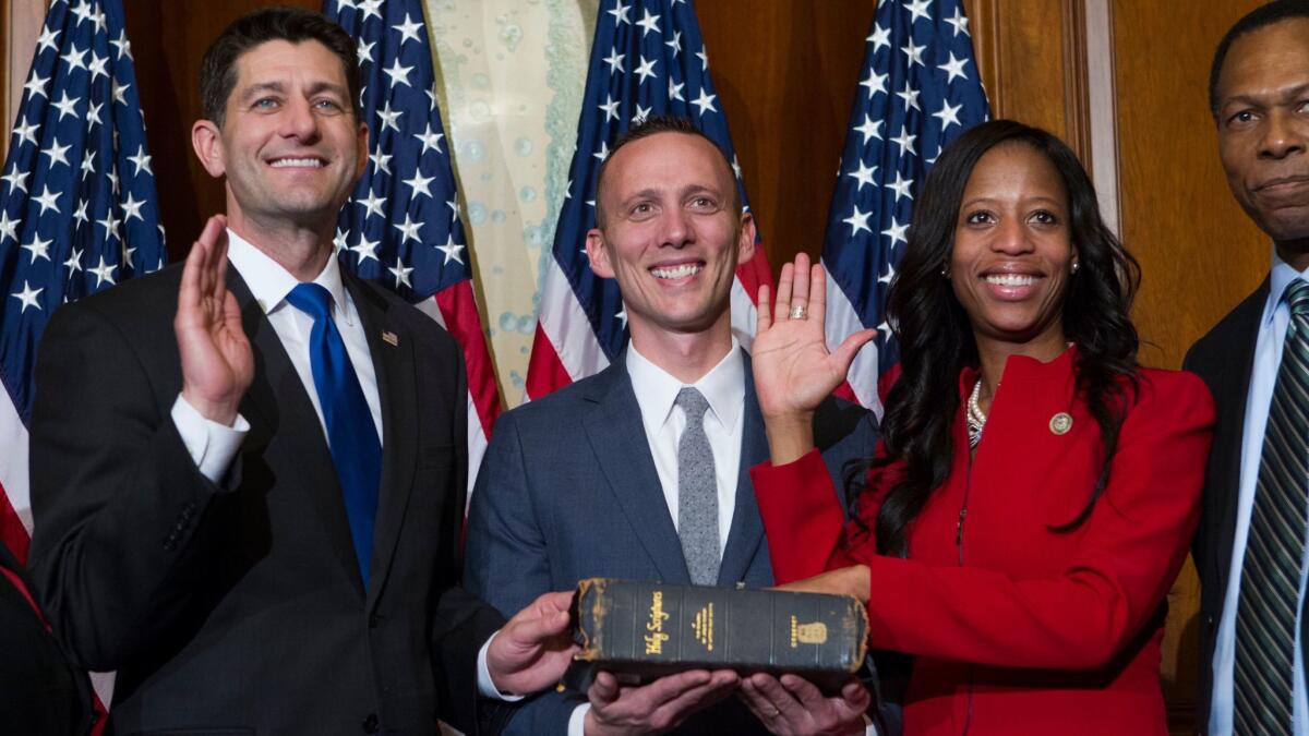 House Speaker Paul D. Ryan (R-Wis.), left, administers the House oath of office to Rep. Mia Love (R-Utah) during a mock swearing-in in January.