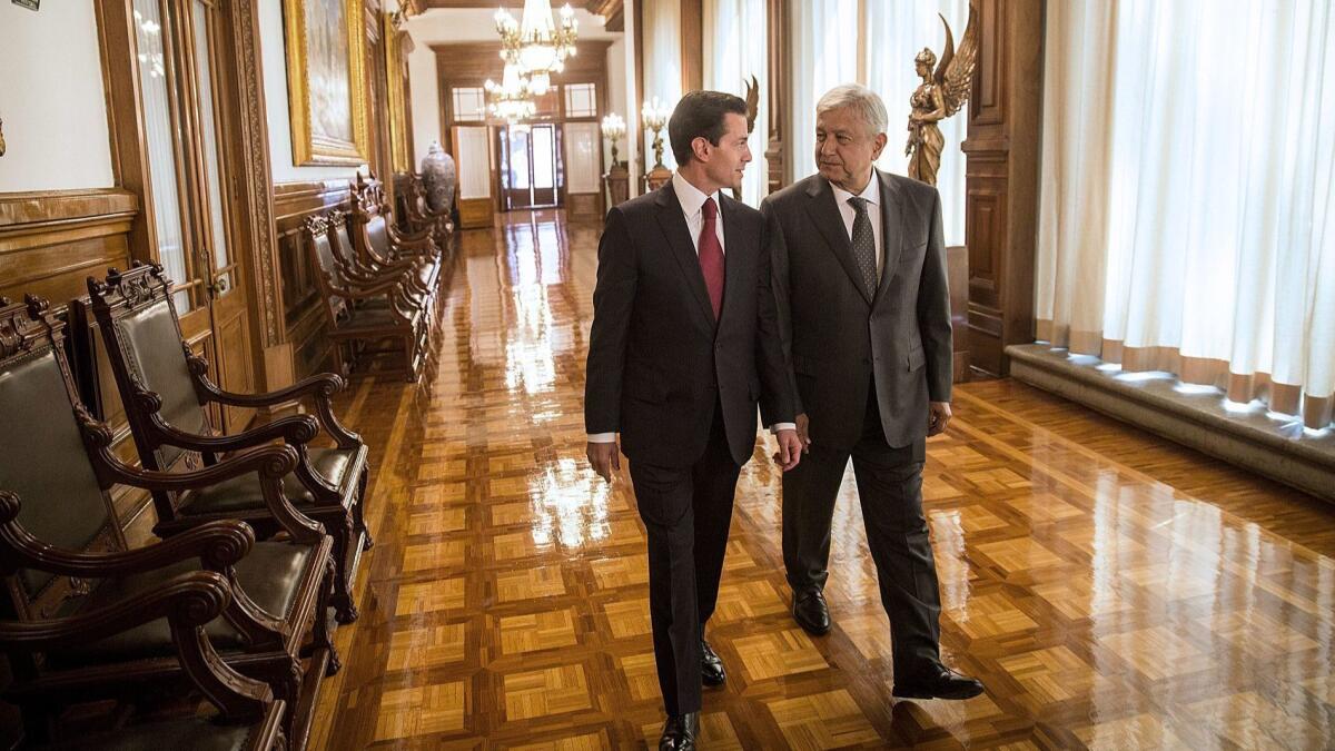 Mexico's President-elect Andres Manuel Lopez Obrador, right, speaks with current president, Enrique Peña Nieto, at the National Palace in Mexico City.