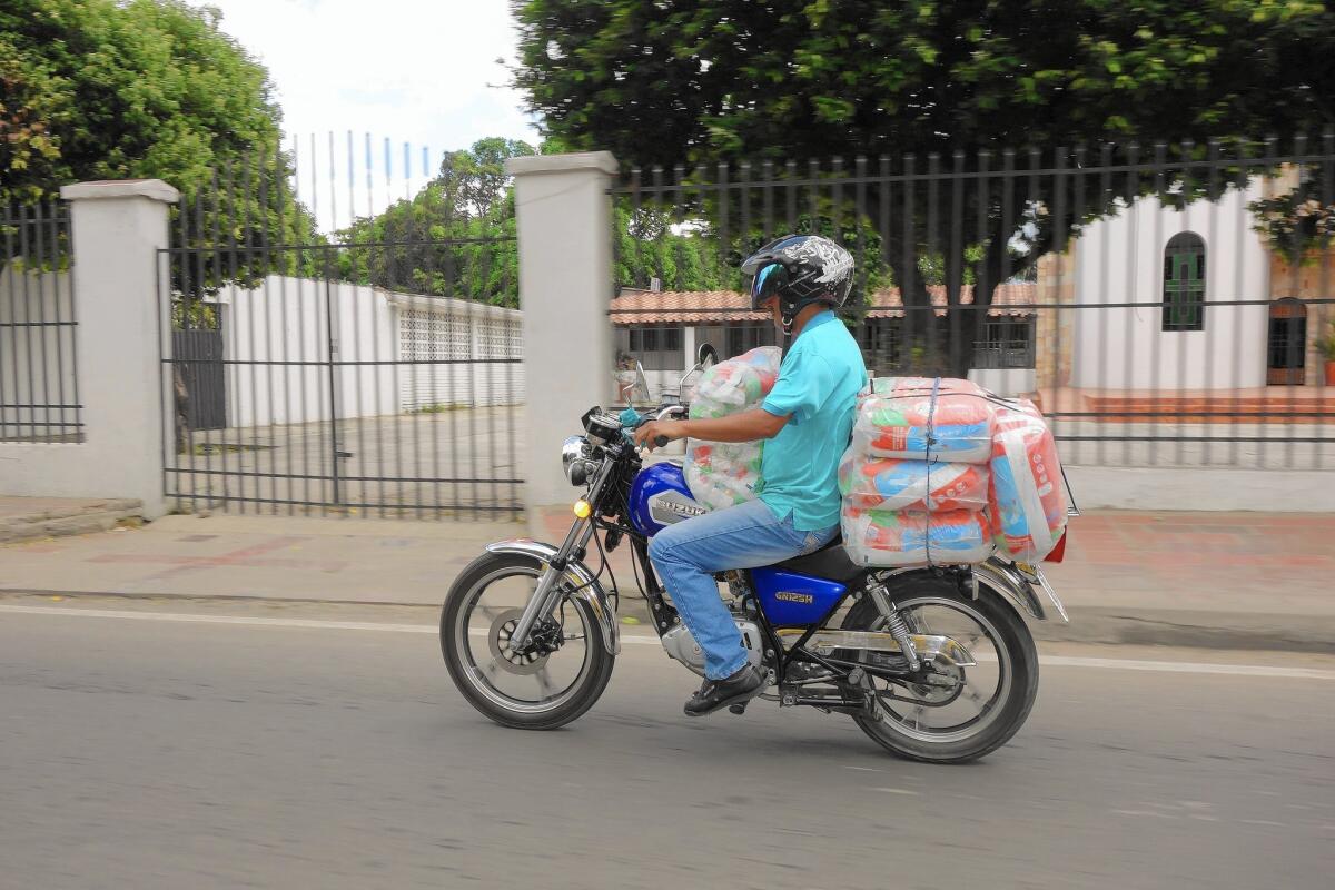 A man ferries goods that are heavily subsidized by the Venezuelan government into Cucuta, Colombia, where they are discounted but still sold at a large profit.