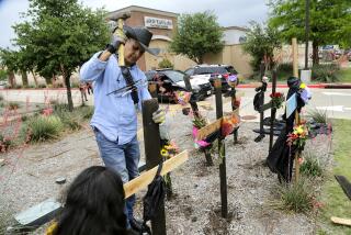 ALLEN, TEXAS - MAY 7: Roberto Marquez of Dallas constructs a wooden cross memorial at the scene of a mass shooting a day earlier at Allen Premium Outlets on May 7, 2023 in Allen, Texas. According to reports, a shooter opened fire at the outlet mall, killing eight people. The gunman, who has not been identified, was then killed by an Allen Police officer responding to an unrelated call. (Photo by Stewart F. House/Getty Images)
