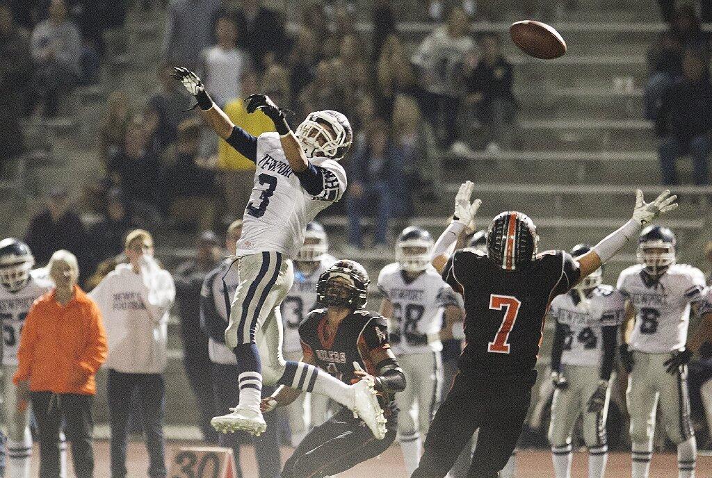 Newport Harbor's Keaton Cablay, left, can't get to a pass intended for him during a game against Huntington Beach on Friday.