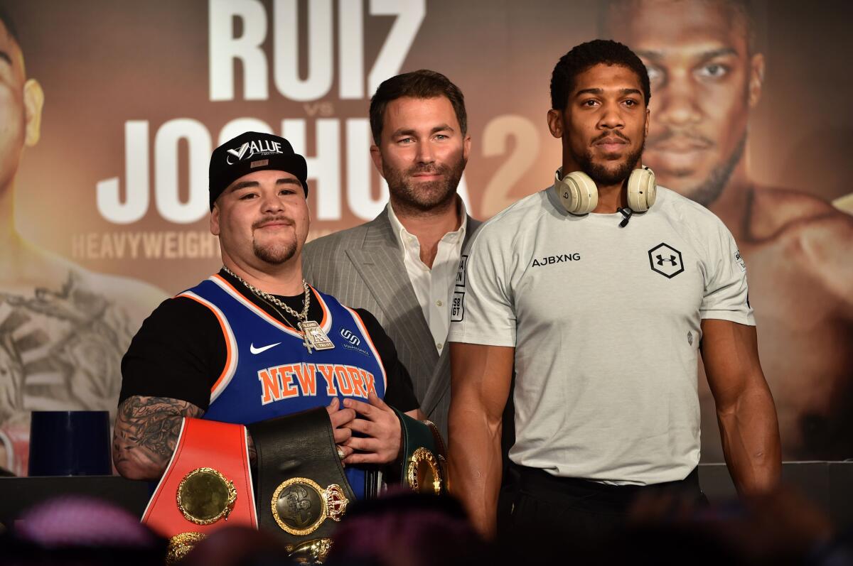 Mexican-American heavyweight boxing champion Andy Ruiz Jr (L) Eddie Hearn (C) and British heavyweight boxing challenger Anthony Joshua (R) are pictured during their press conference in Diriyah in the Saudi capital Riyadh, on December 4, 2019, ahead of the upcoming "Clash on the Dunes". - The hotly-anticipated rematch between Ruiz Jr and British challenger Anthony Joshua is scheduled to take place in Diriya, near the Saudi capital on December 7. (Photo by FAYEZ NURELDINE / AFP) (Photo by FAYEZ NURELDINE/AFP via Getty Images) ** OUTS - ELSENT, FPG, CM - OUTS * NM, PH, VA if sourced by CT, LA or MoD **