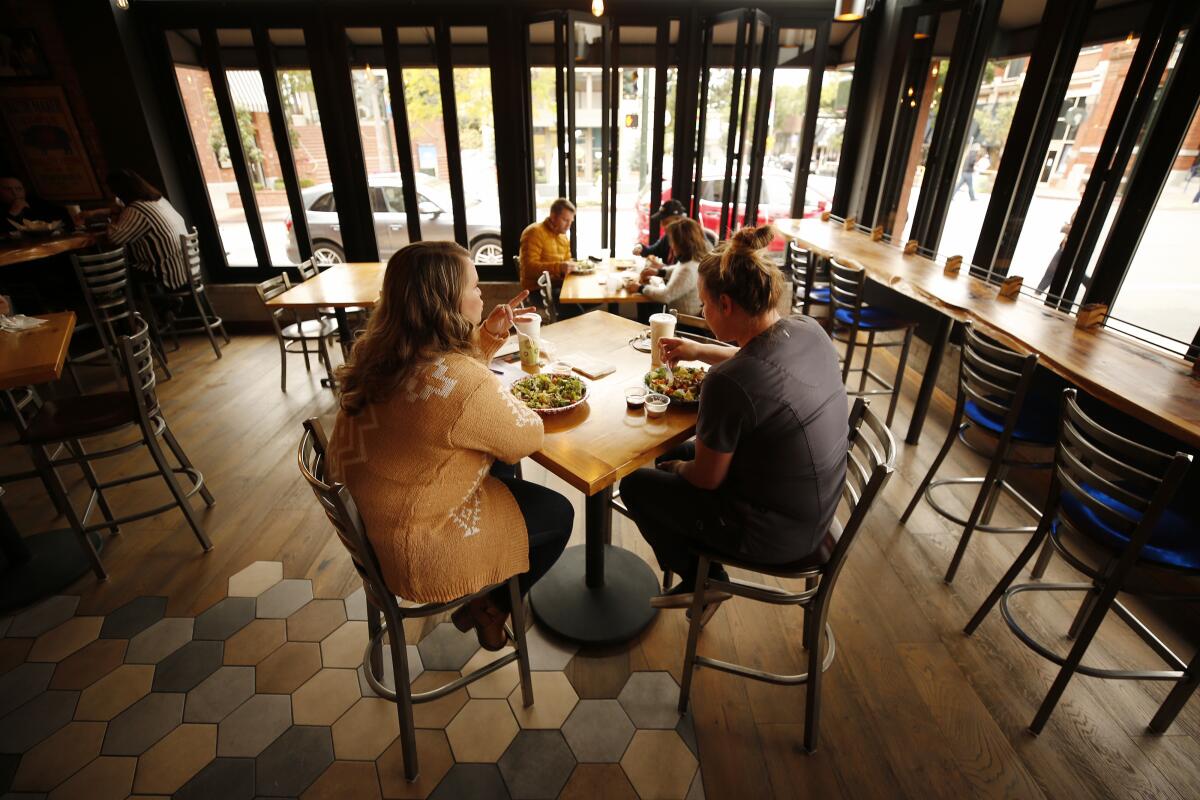 Diners eat inside a restaurant in San Luis Obispo.