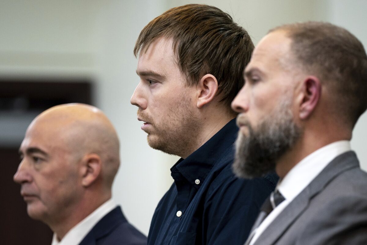 Travis Reinking, center, reacts as the verdict is read during day five of Reinking's murder trial at the Justice A.A. Birch Building in Nashville, Tenn., Friday, Feb. 4, 2022. A jury found Reinking guilty of first-degree murder in the deaths of four people at a Waffle House in 2018. (Andrew Nelles/The Tennessean via AP, Pool)