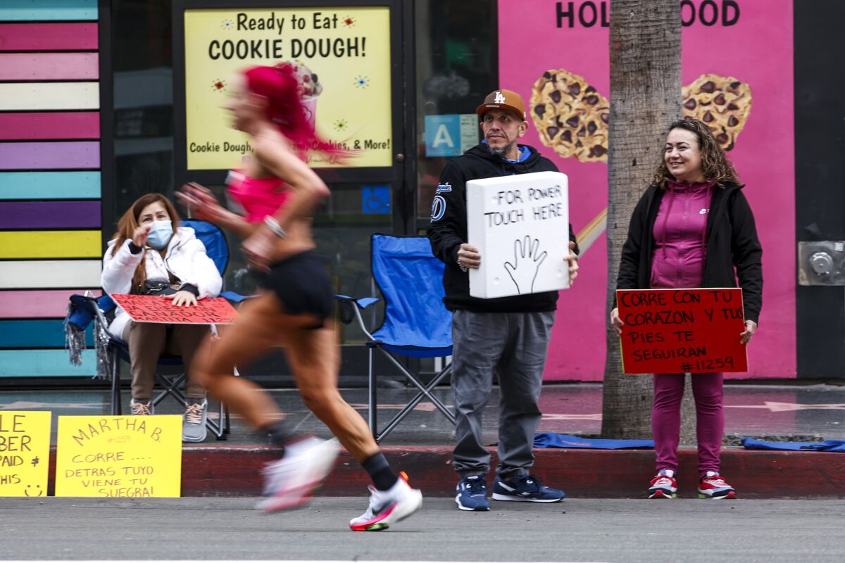 A runner runs along Hollywood Blvd during the 38th LA Marathon.