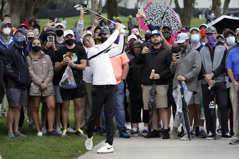 Viktor Hovland, of Norway, hits a shot from the cart path off the 16th fairway during the third round of the Arnold Palmer Invitational golf tournament Saturday, March 6, 2021, in Orlando, Fla. (AP Photo/John Raoux)