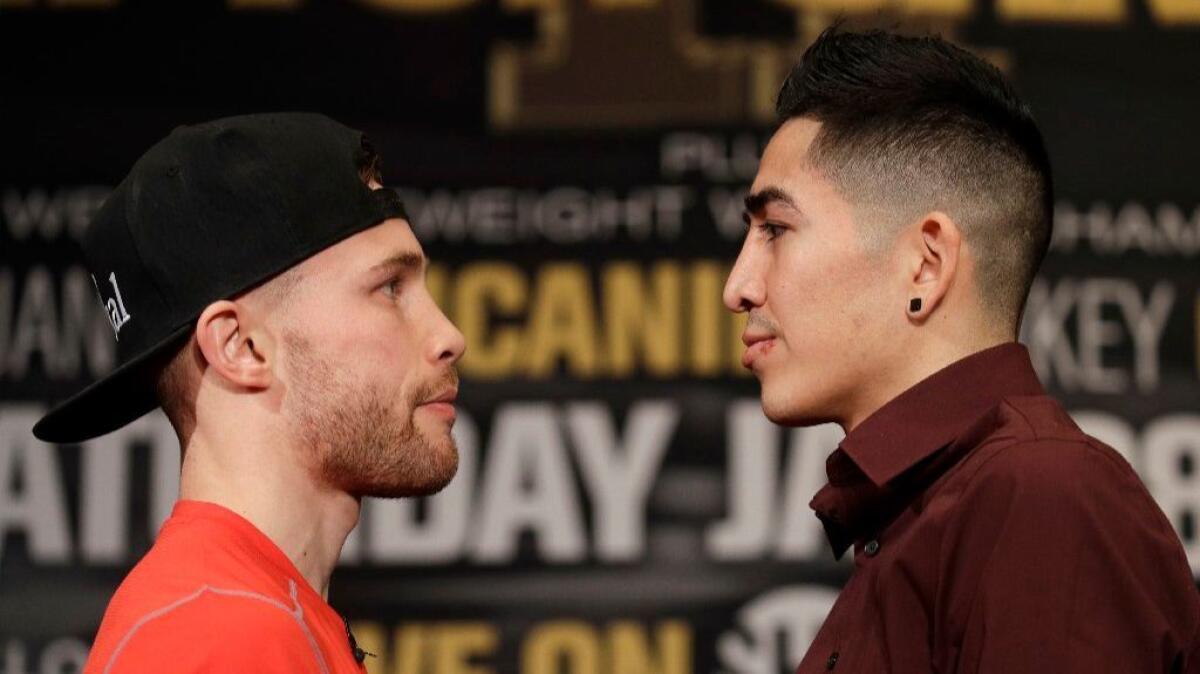 Boxers Carl Frampton and Leo Santa Cruz stare each other down during a news conference in Las Vegas on Jan. 26.