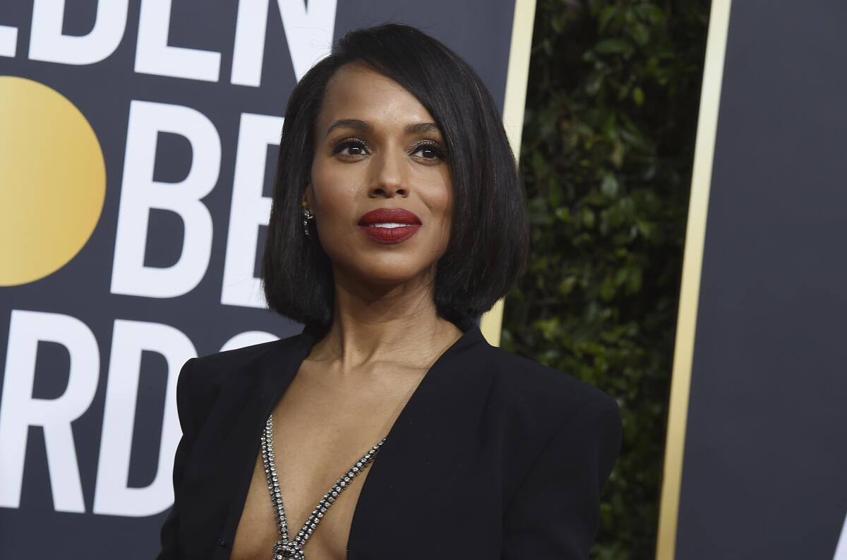 Kerry Washington poses at Golden Globes in a black jacket with nothing underneath but a long necklace