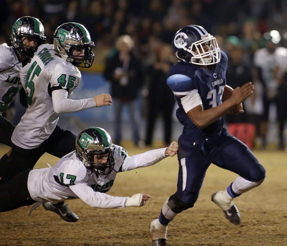 Camarillo running back Isaiah Otis breaks free from a trio of Thousand Oaks defenders en route to a touchdown.