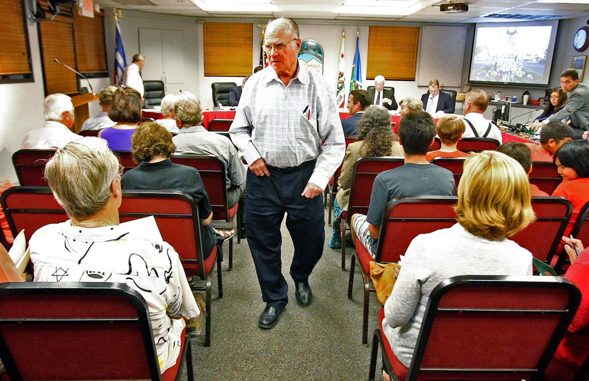 Rody Stephenson, of La Cañada, walks through council chambers at a La Cañada Flintridge council meeting where several citizens attended to speak on behalf of a ban on plastic bags on Monday, September 16, 2013. Stephenson is leading an initiative to ban plastic bags, or apply a $0.10 fee per bag use in the city.