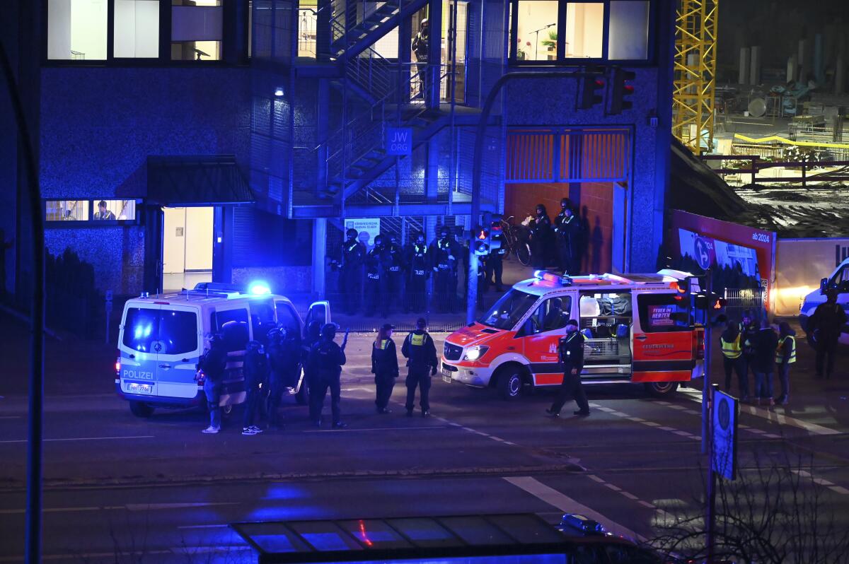 Police and emergency vehicles outside a church that was the scene of a shooting in Hamburg, Germany