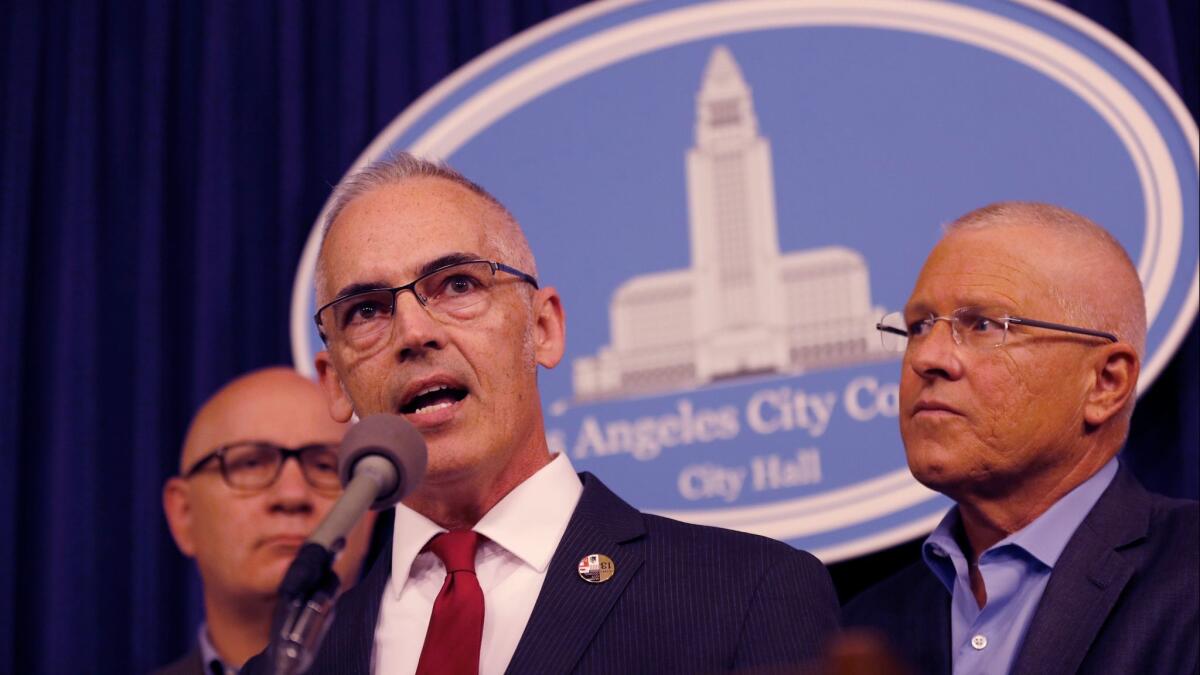 Los Angeles City Councilmen Mitch O'Farrell, center, and Mike Bonin, right, said Tuesday they have been inundated with complaints about higher trash bills and missed refuse pickups under RecycLA, the city's new recycling program.