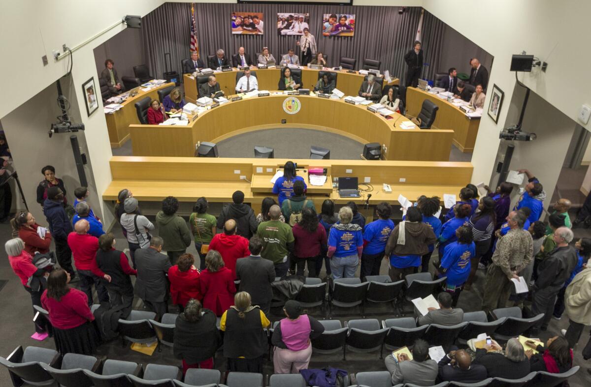 The Los Angeles Unified school board is seen meeting with parents, teachers and students earlier this year. In March, voters will choose board members for three of the seven school board seats.