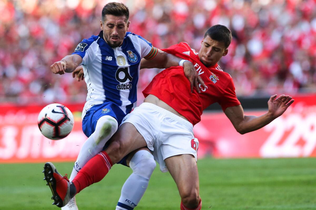 Benfica`s Ruben Dias (R) fights for the ball with Hector Herrera of FC Porto during their Portuguese First League soccer match held at Luz stadium, Lisbon, Portugal, 7th October 2018.