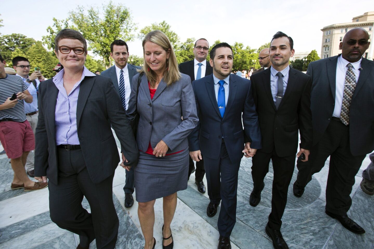 Plaintiffs Kristen Perry and Sandy Stier, left, and Jeffrey Zarrillo and Paul Katami arrive at the Supreme Court Wednesday morning to hear the high court's ruling on California's Proposition 8, which forbids on same-sex marriage.