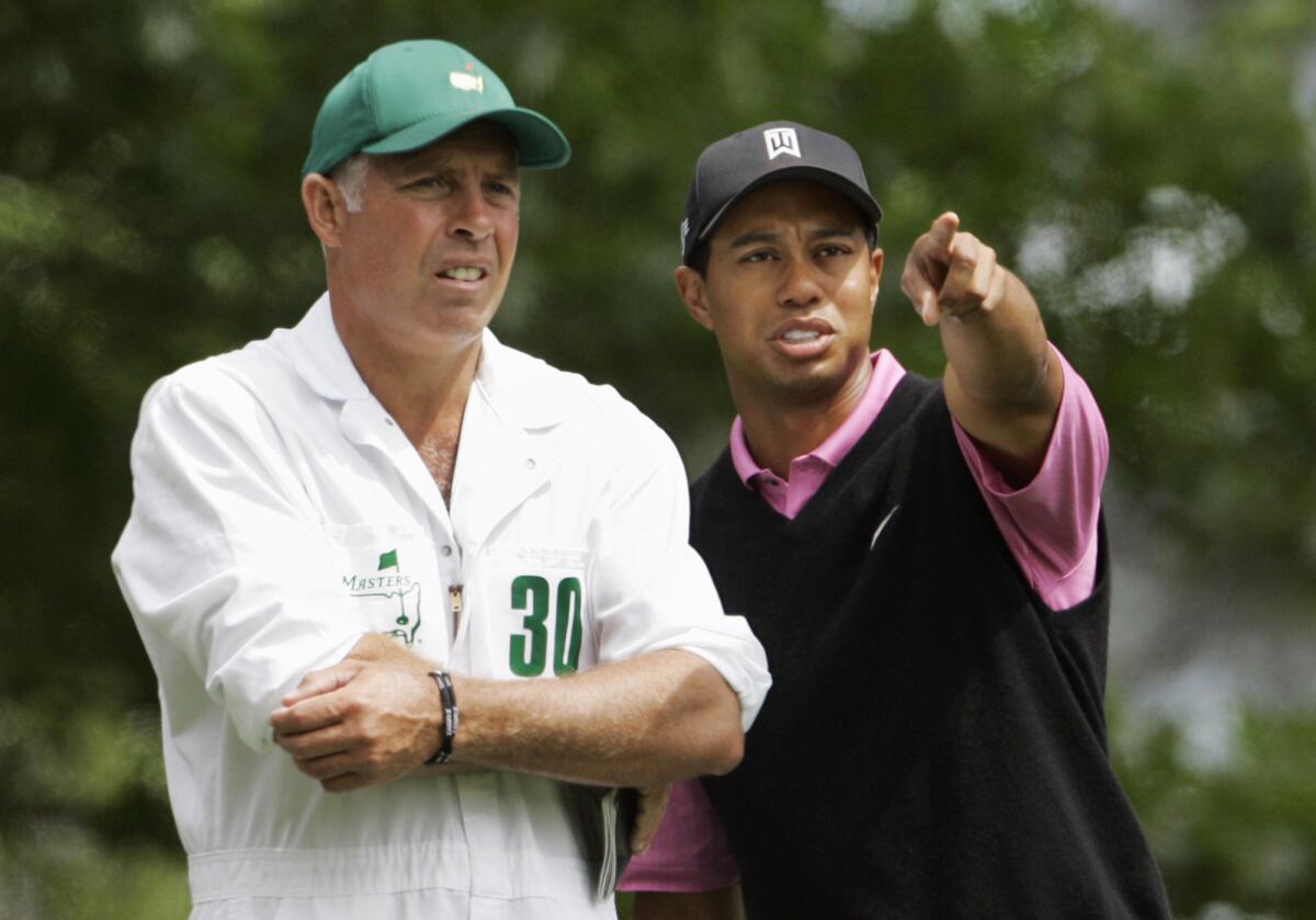 Tiger Woods confers with his then-caddie, Steve Williams, on the sixth hole during the 2007 Masters tournament.