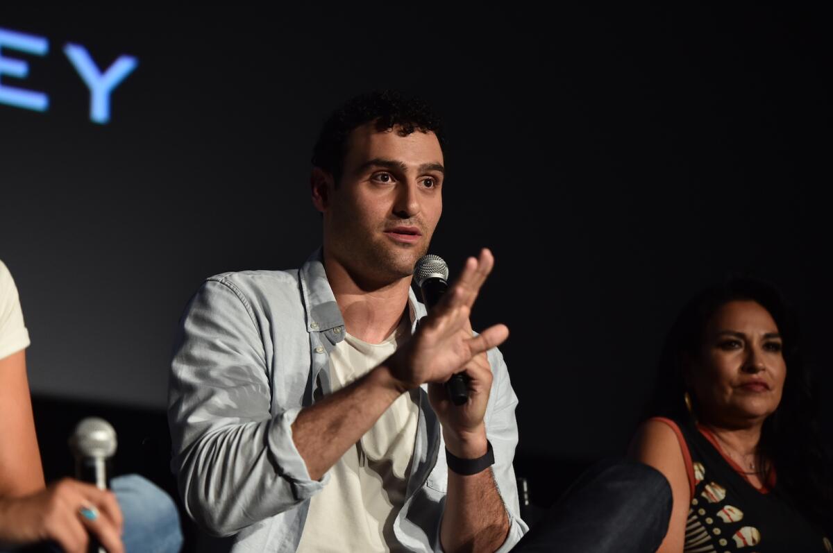 A man with a microphone answers questions.