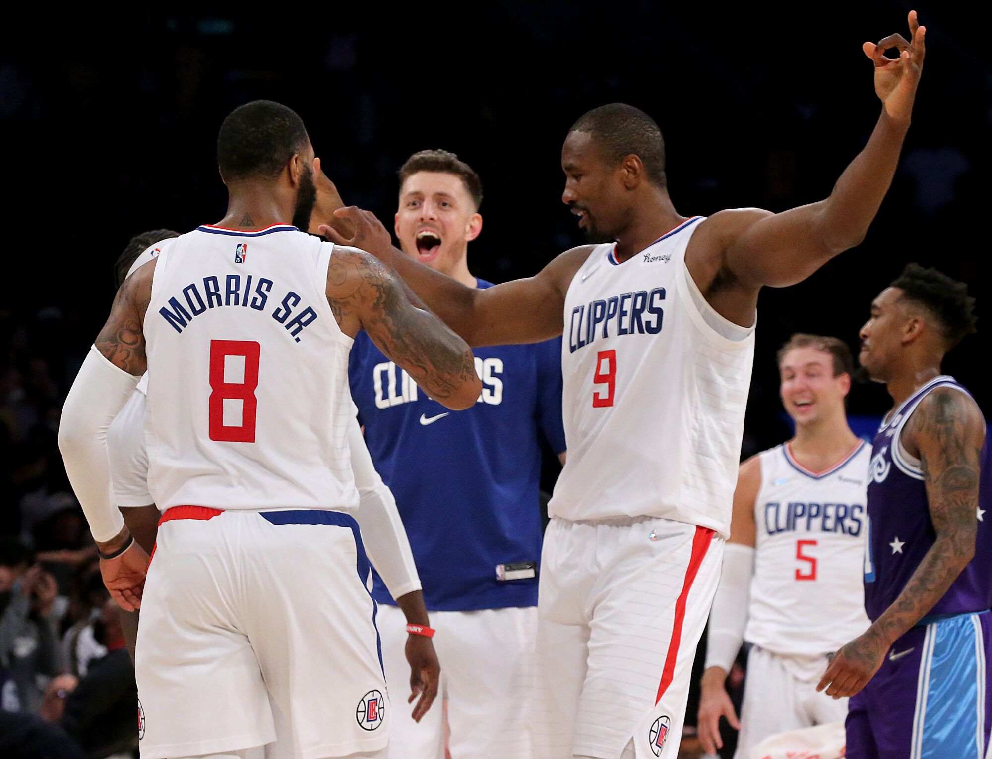 Clippers forward Marcus Morris Jr. is congratulated by teammates Isaiah Hartenstein, center, and Serge Ibaka.