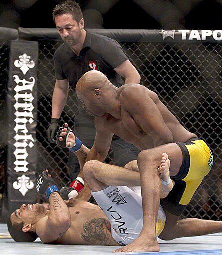 Anderson Silva throws the final punch to earn a technical knockout over Vitor Belfort in the first round of their Ultimate Fighting Championship middleweight title fight on Saturday night in Las Vegas.