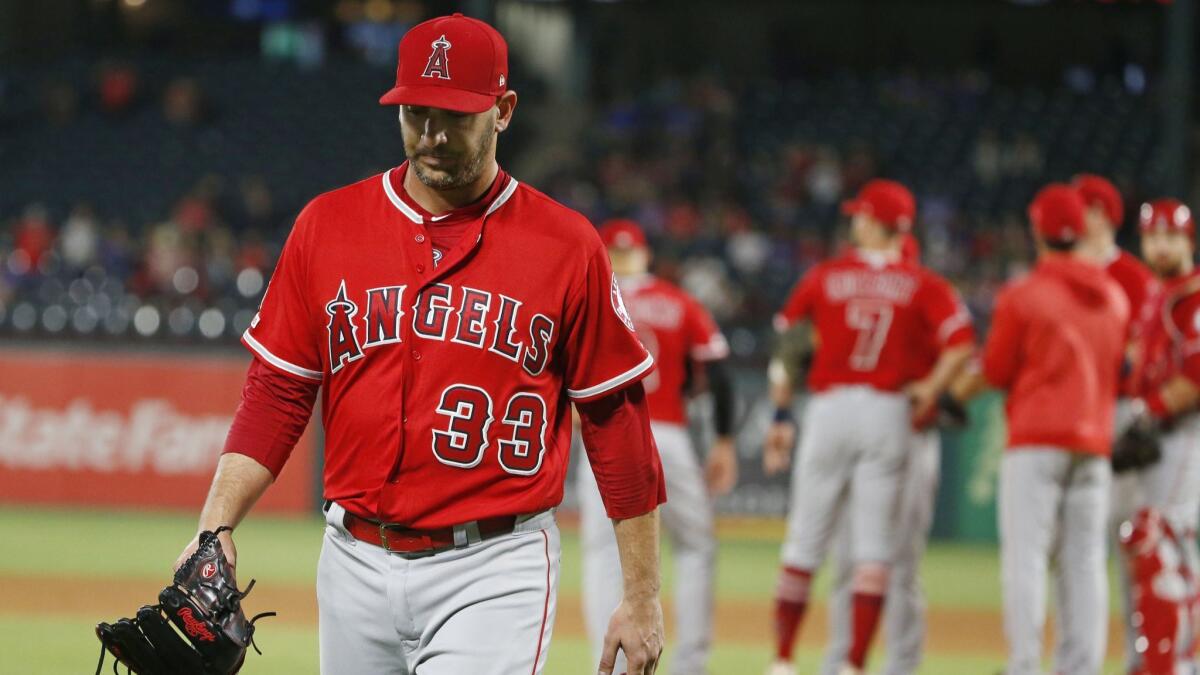 Angels starter Matt Harvey walks off after being removed in the fifth inning against the Texas Rangers.