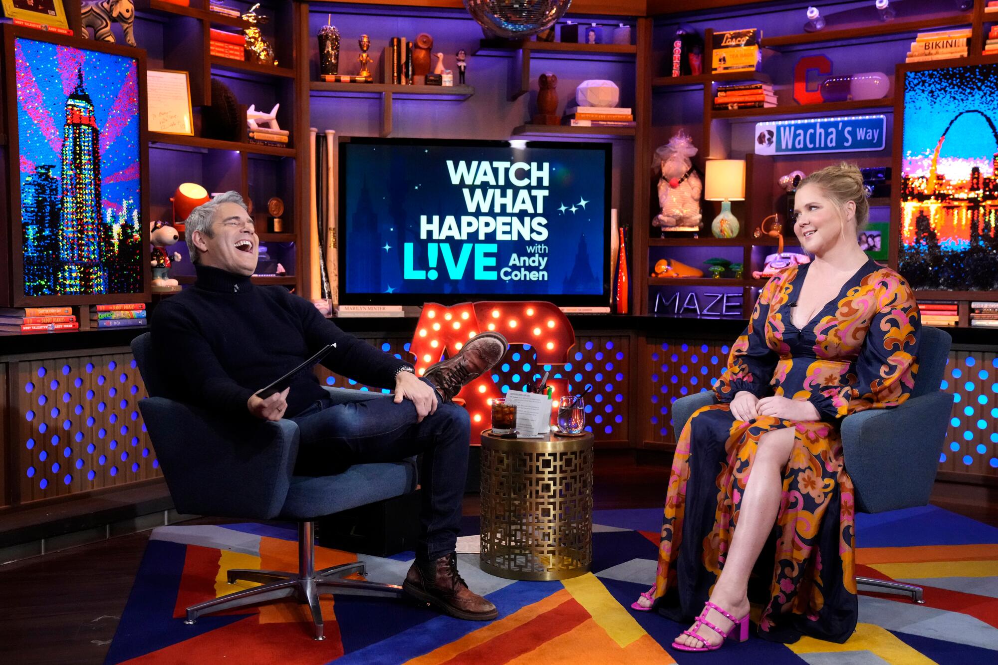 Andy Cohen laughs on the set of "What What Happens Live" with guest Amy Schumer