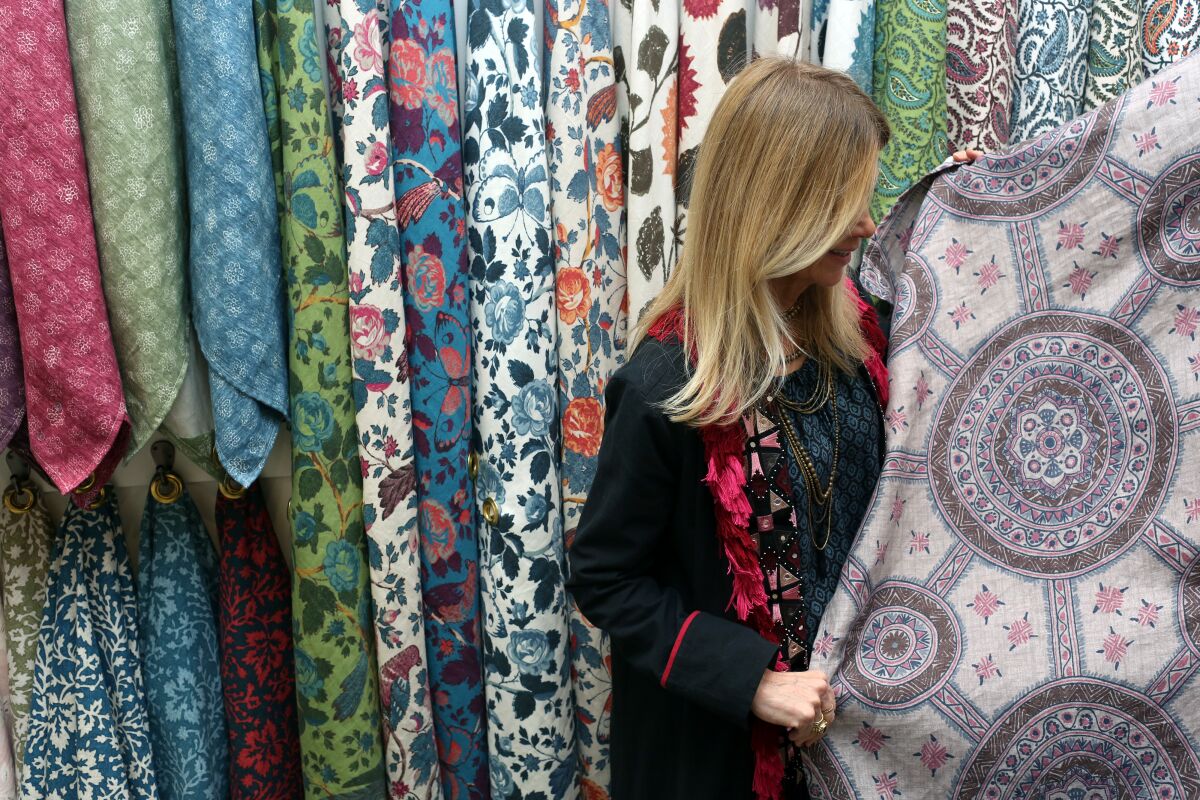 Schuyler Samperton examines her textiles hanging in the showroom at Hollywood at Home. 